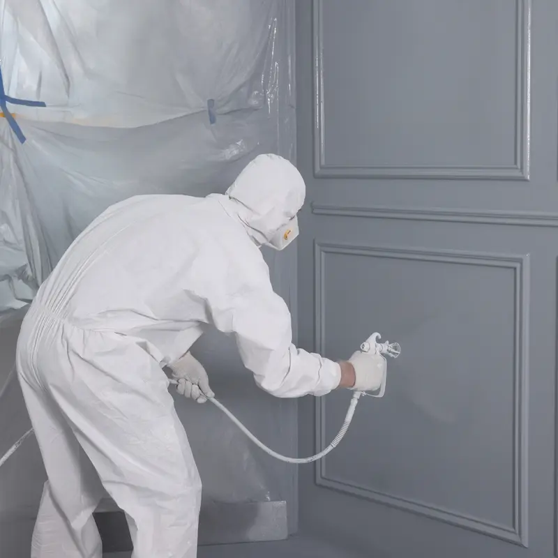 Experienced Painter Spray Painting Cabinets 